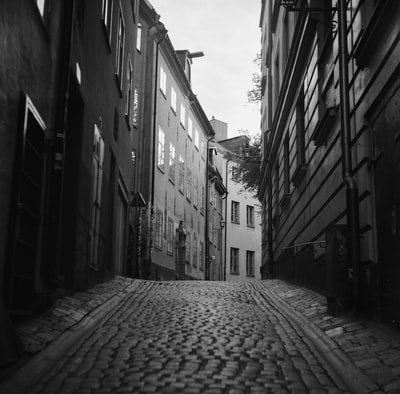 Between buildings empty streets of gray-scale images

